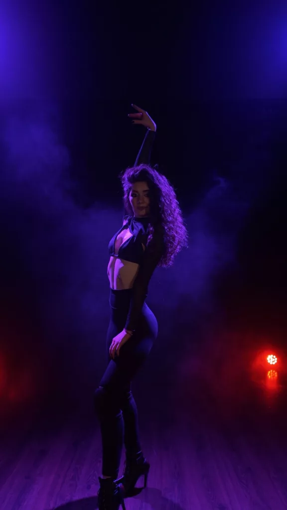 Close-up of Metaxa’s delicate frame in black lingerie, submissive camgirl vibes.