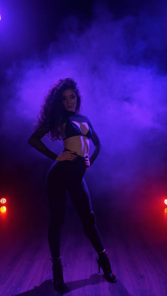 Metaxa, submissive camgirl, kneeling with hands tied, sensual BDSM pose.