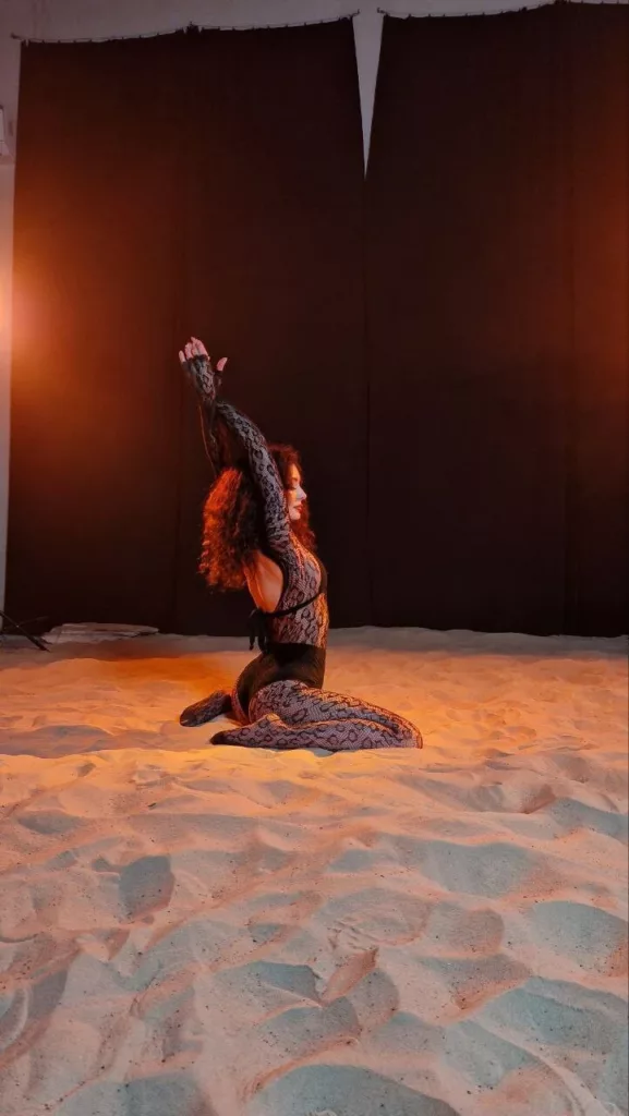 Metaxa’s green eyes sparkling, submissive camgirl whispering to fans on cam.