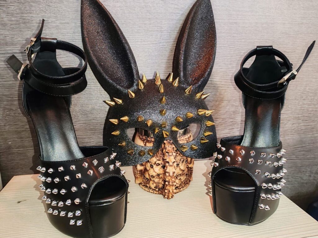 Black studded high heels with glittery bunny ears, spiked band, gold studs.