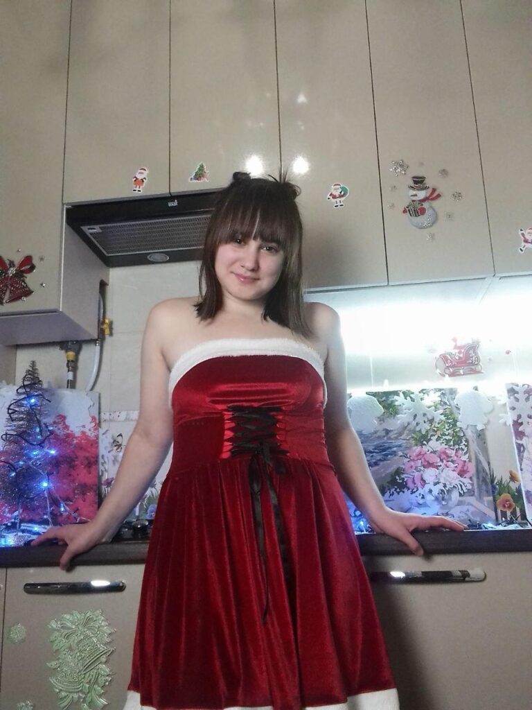 LadyBi is wearing a red holiday dress