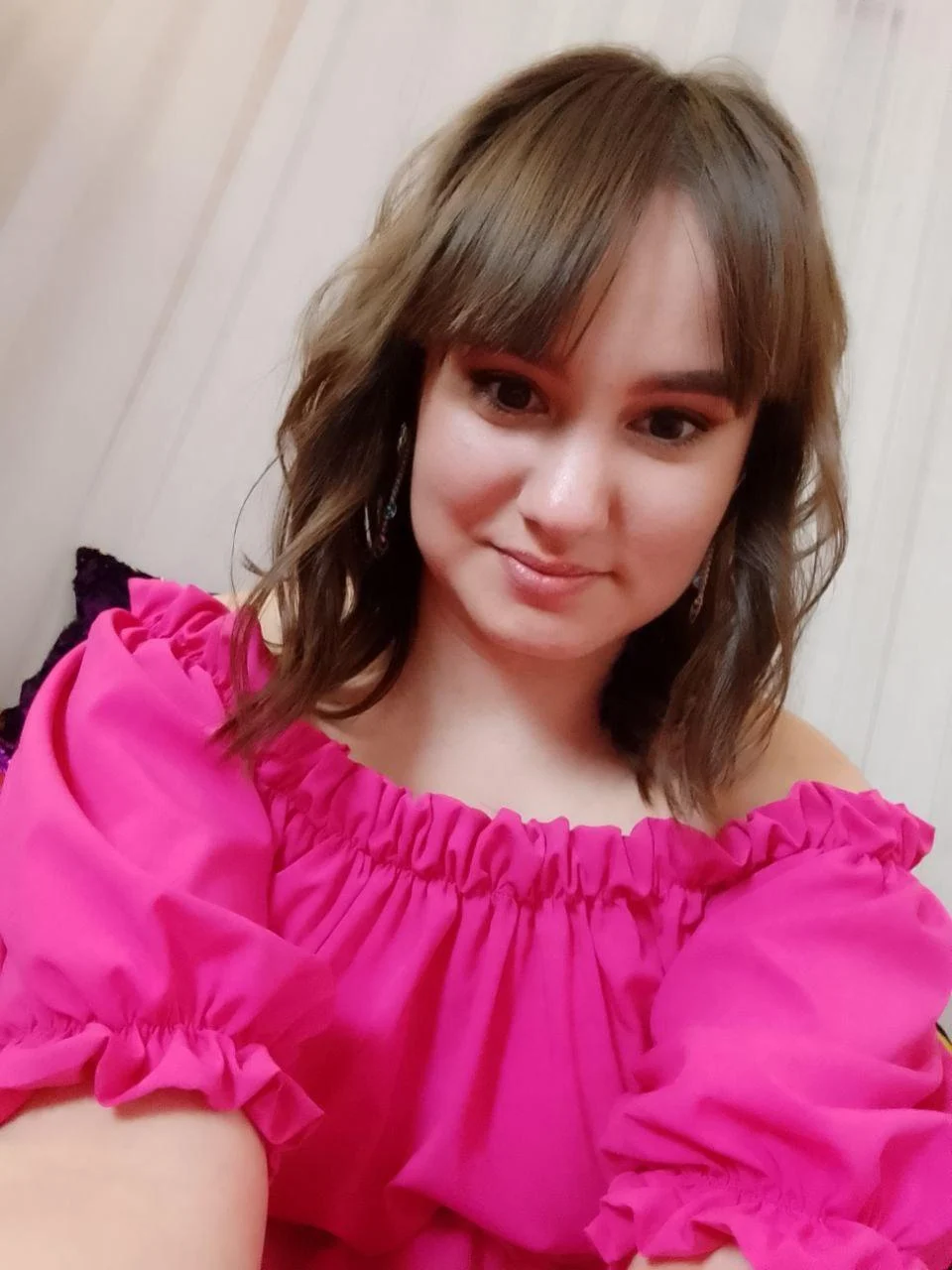LadyBi is wearing a pink dress
