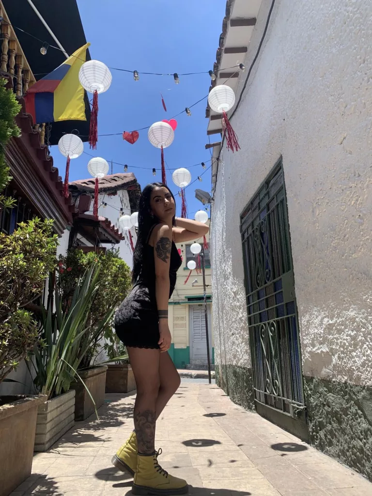 sarahluna out in the wild, yellow boots and black dress