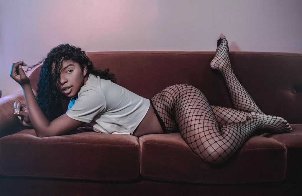 LisaMendez is on a couch with her ass up with hair over her face in a sexy pose