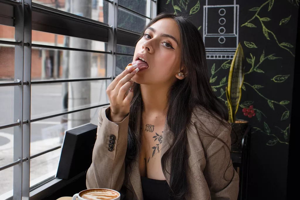 chanelderosee eating a breakfast treat seductively in a short skirt attire