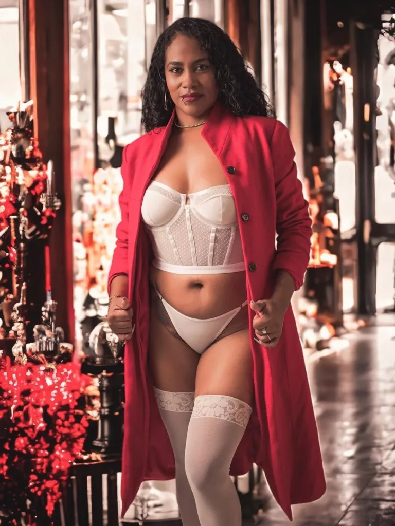 ebonysauvage stands tall as she shows of her phenomenal body in her white lingerie set with a red coat on