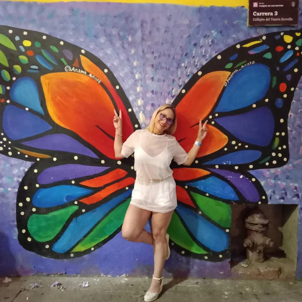 janeturner having a fun time out on the town taking a photo between butterfly wings