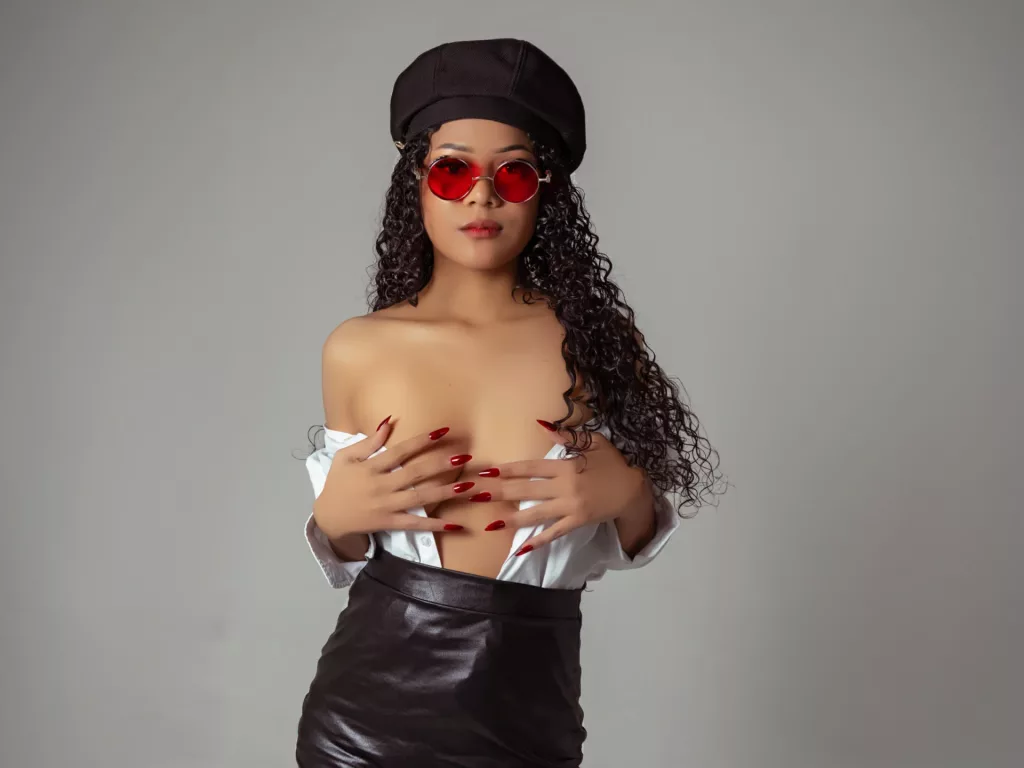 Badraduquell is topless in her beret hat and black latex shirt