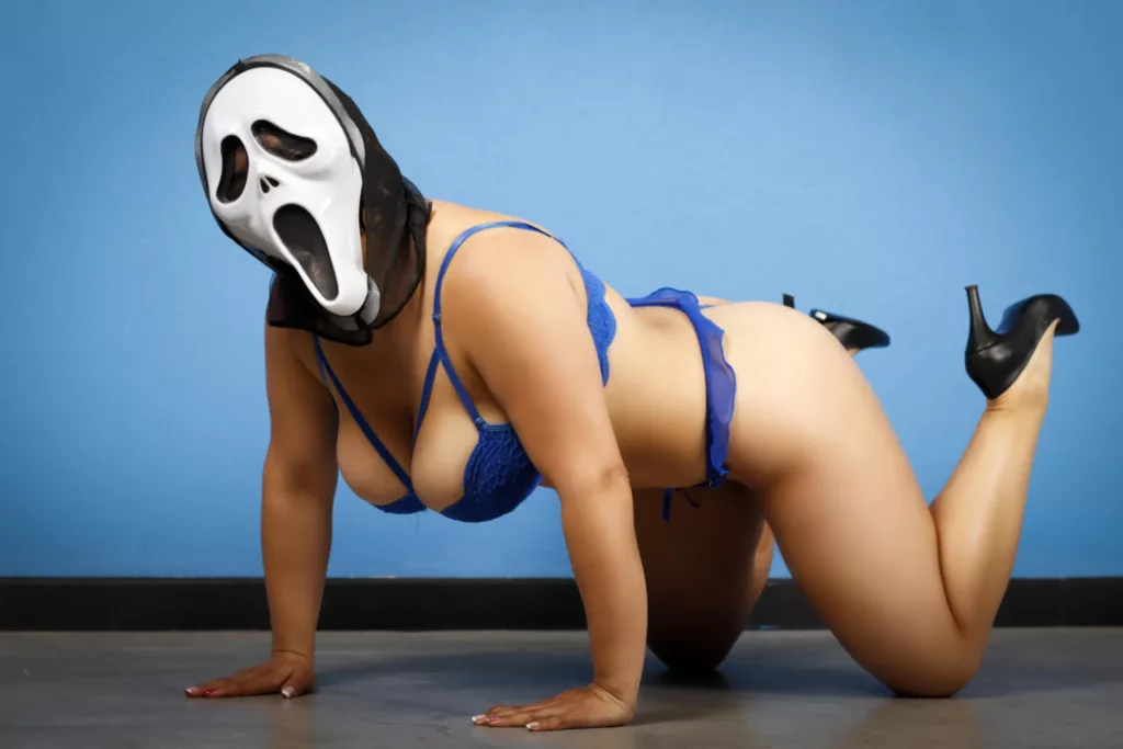 becck wears a scream mask as she is dress in blue underwear with black heels on