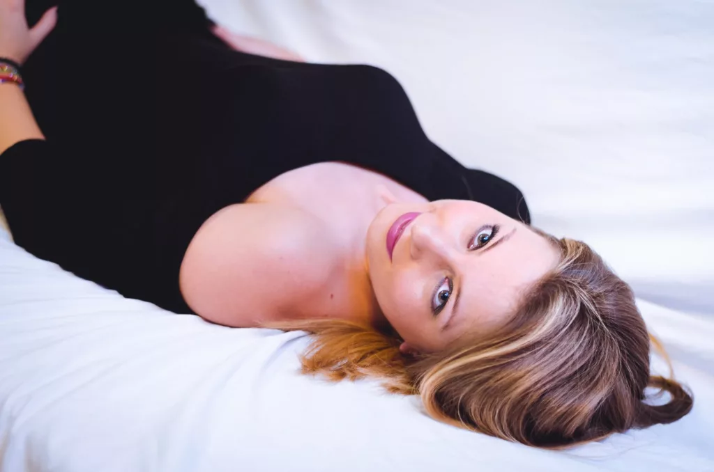 DeliceSmille lays on her back looking up in the camera