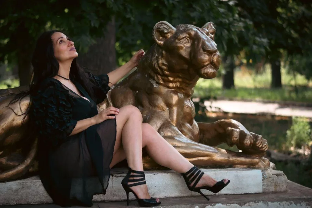 GinaONeon lays out her long legs on a golden tiger