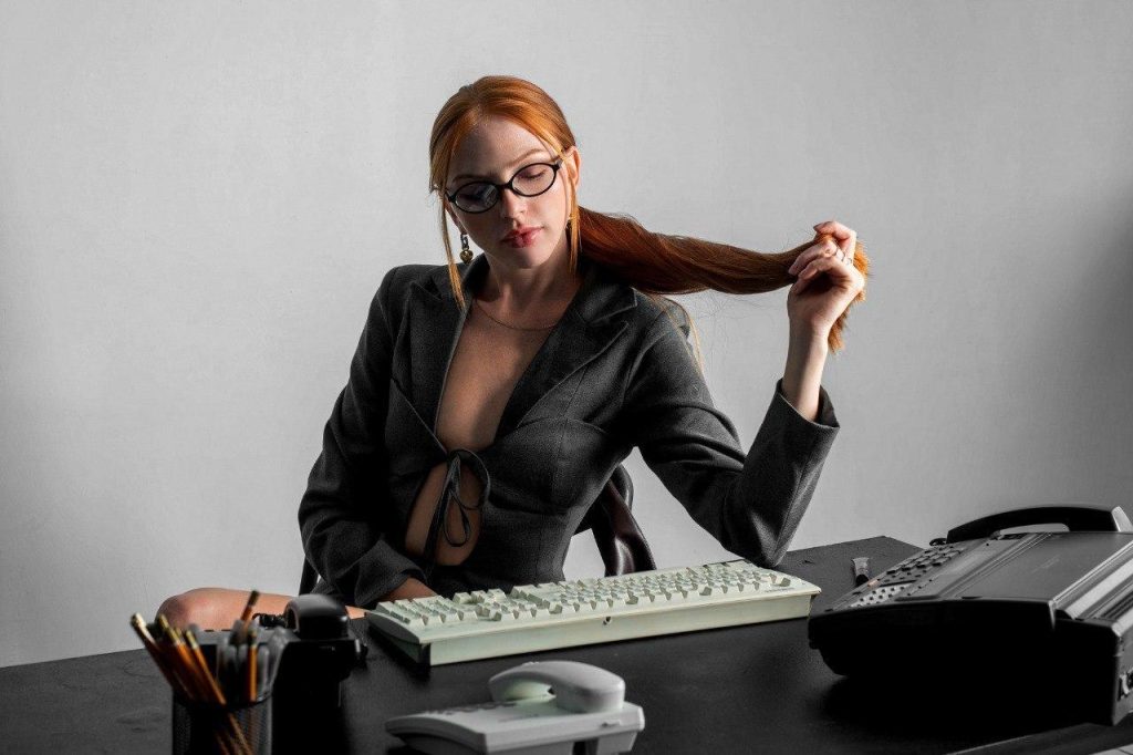 ginger camgirl sites at desk in sexy work boss suit