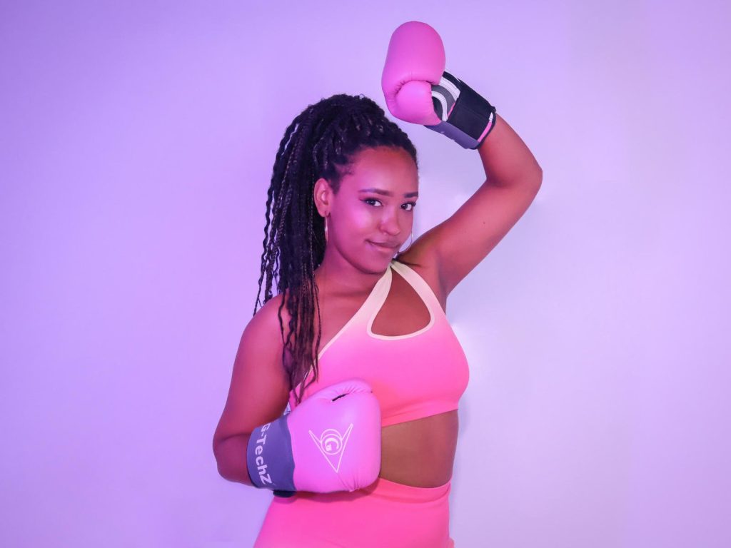 Naomi in boxing gloves, playful jab with a seductive smirk.