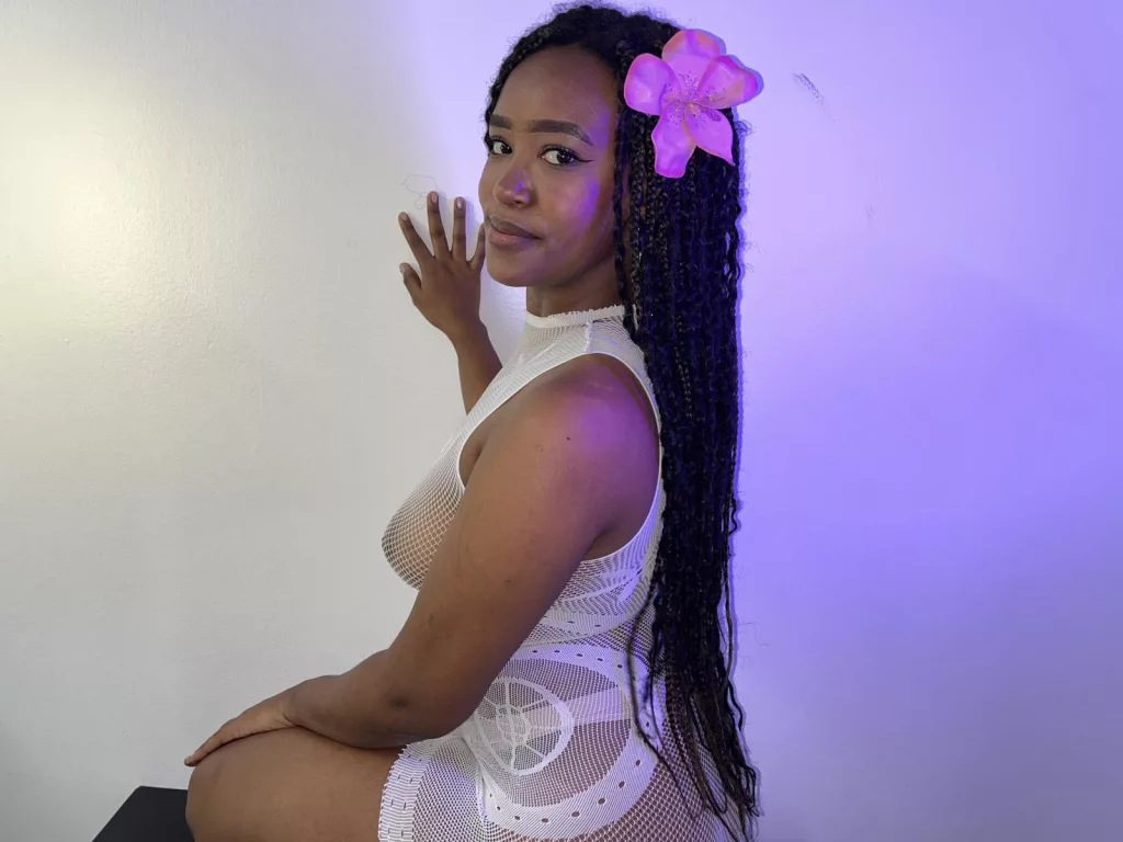 Long black hair cascades as Naomi teases in lingerie.
