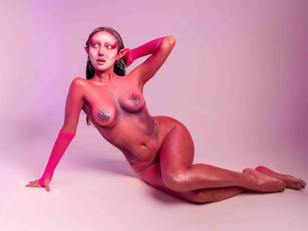 CarlaFranco nude with wet skin, pink gloves, chain belt—light fairy porn vibes
