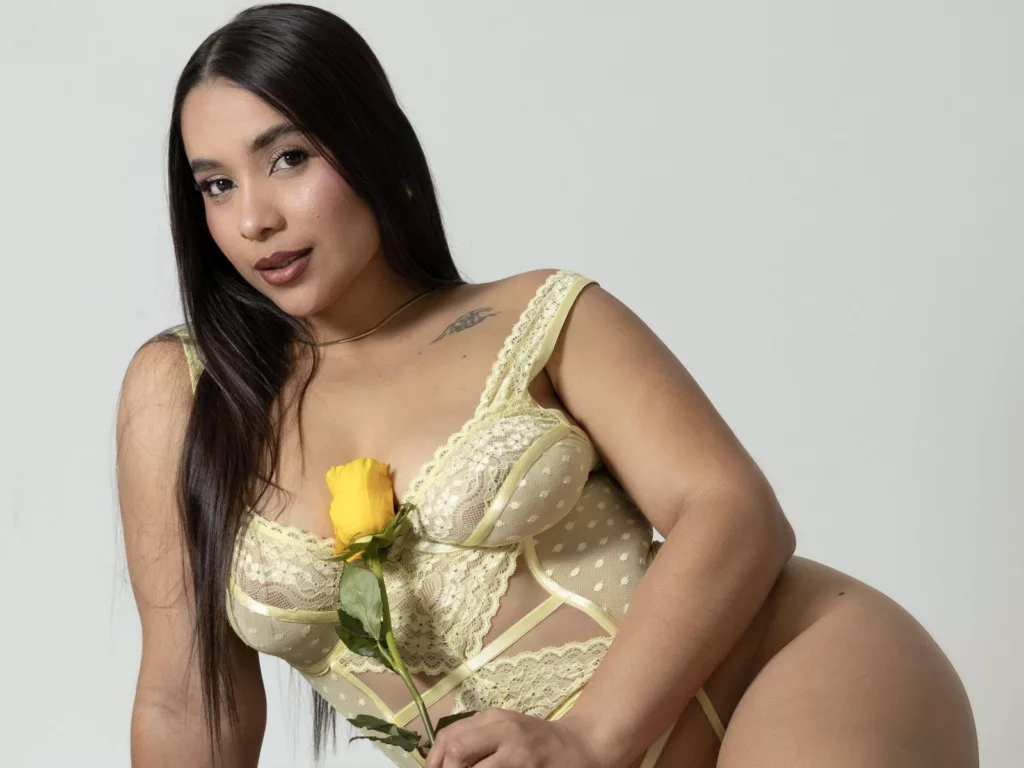 LucyCarson in yellow lace lingerie, holding a yellow rose.