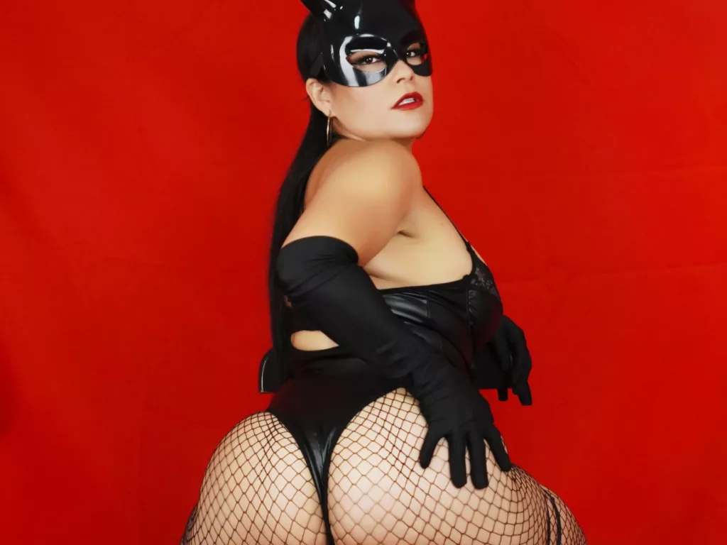 TamaraFoxy in latex bunny outfit, posing boldly with gloves and fishnet stockings