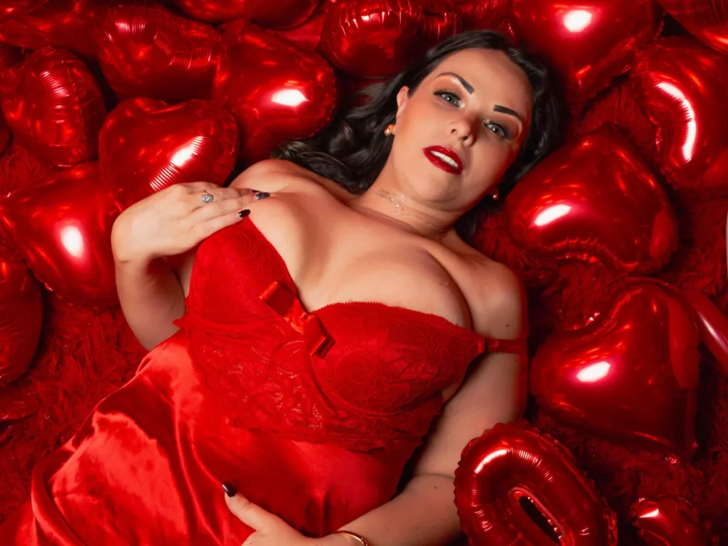 MelissaLeen with heart balloons, red dress, living her best milf life, bold glamour.