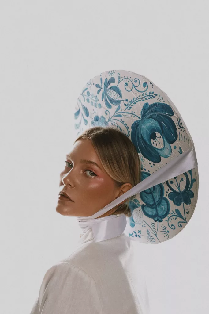 EolantaMarina in white dress, blue floral hat, light blush, looking off to side