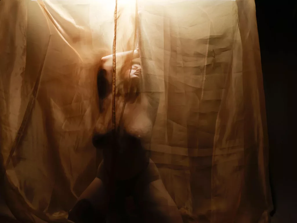 ChristineBray in shadowy light, ethereal, mysterious, birthday sex ideas with dramatic flair.