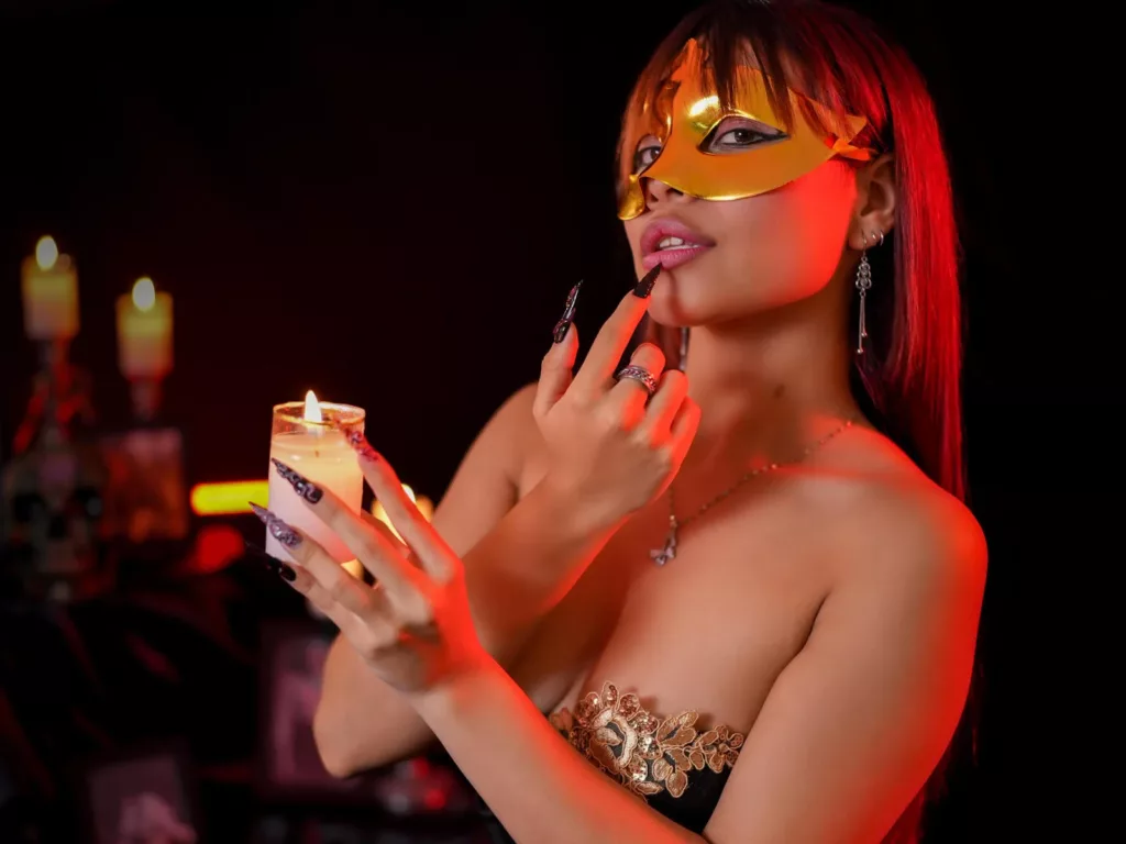 VannesaSaenz in gold mask, candlelit, sensual touch, mask sex allure.