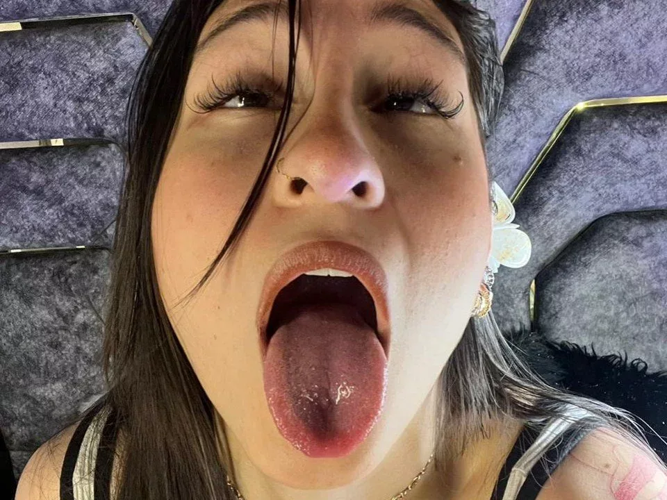 MaddyCarina: tight skirt play, black tank top, tongue out, high-contrast