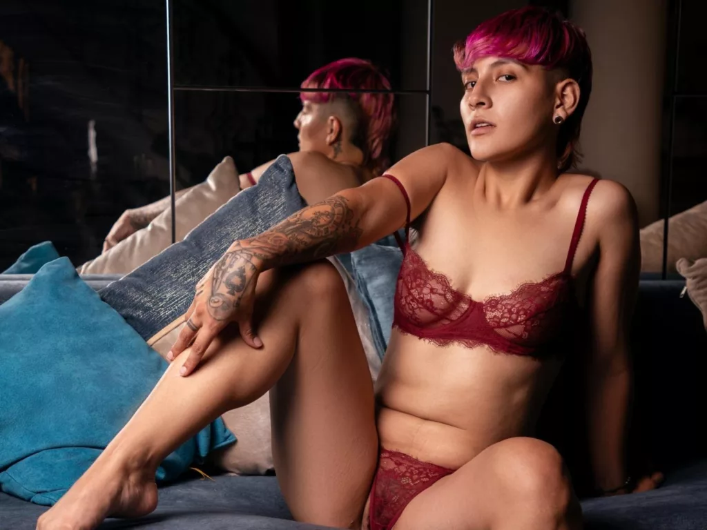 DannyRouds: tomboy girlfriend in red lace lingerie, pink hair, blue couch