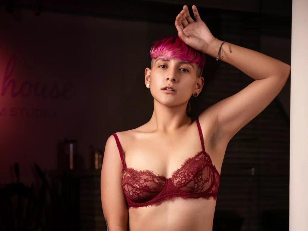DannyRouds: tom boy style in red lace bra, short pink hair, confident pose