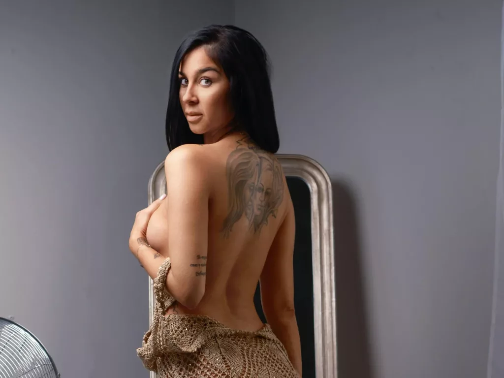 FrancescaDante showing a glimpse of skin and ink; sexy slim milf pics by the mirror.